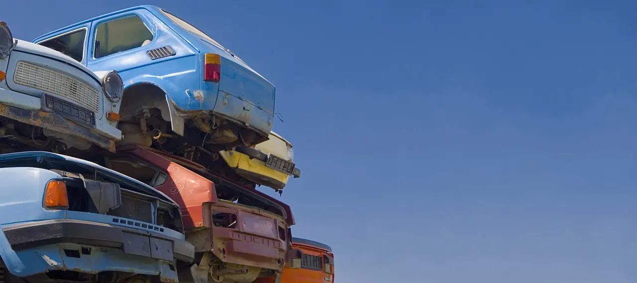 Stack of old junk cars at a recycling yard